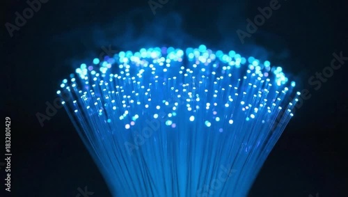 Glowing Blue Fiber Optic Cables with Soft Light and Mist on Dark Background
