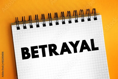 Betrayal - the action of betraying one's country or a person, treachery, text concept on notepad