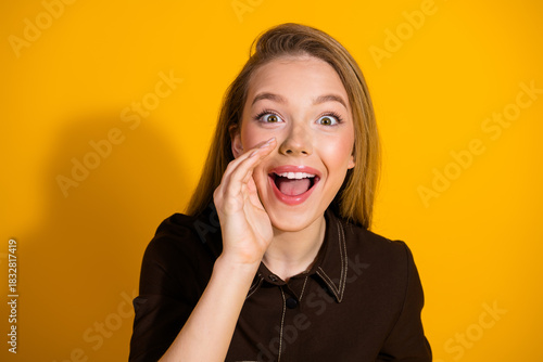 Young happy smiling woman with open mouth on bright yellow background fashion style portrait