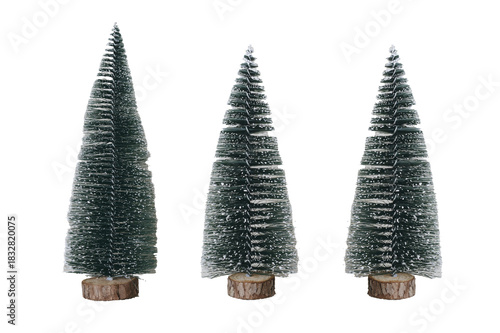 Miniature snowy Christmas trees on white background
