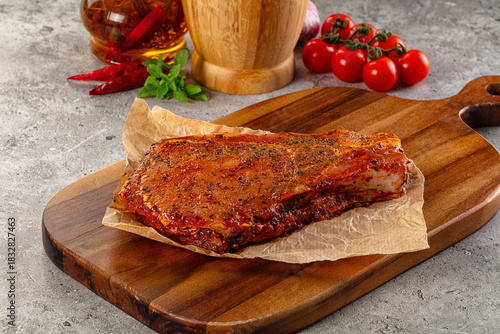 Raw marinated pork loin steak