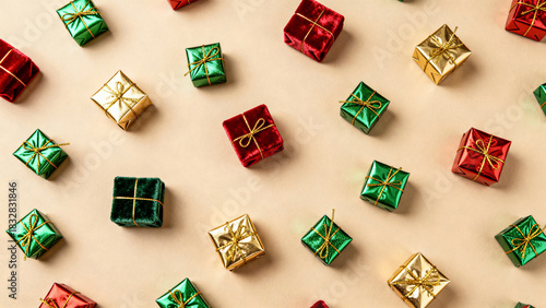 Small Christmas gift boxes in red, green and gold scattered on beige background, festive holiday pattern and decoration 
