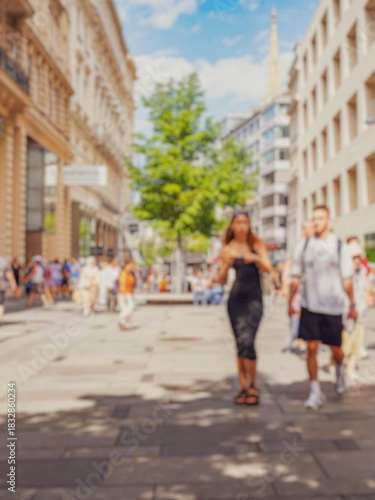 Crowd of anonymous people walking on busy city street