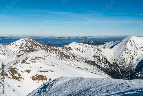 Fototapeta Naklejka Na Ścianę i Meble -  Hrubý vrch, Volovec, Smrek and Derava hills from Baranec hill summit in winter Western Tatras mountains in Slovakia