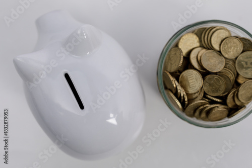 A white piggy bank next to ...