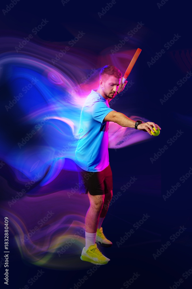 Fototapeta premium Young athlete in action preparing to hit a ball during an energetic sports session