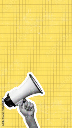 Fotografie Hand holding a megaphone on a yellow grid background for communication and annou