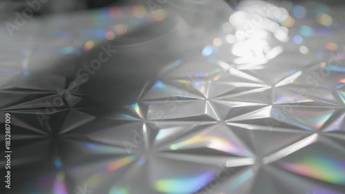 Abstract geometric surface with iridescent light reflections and bokeh