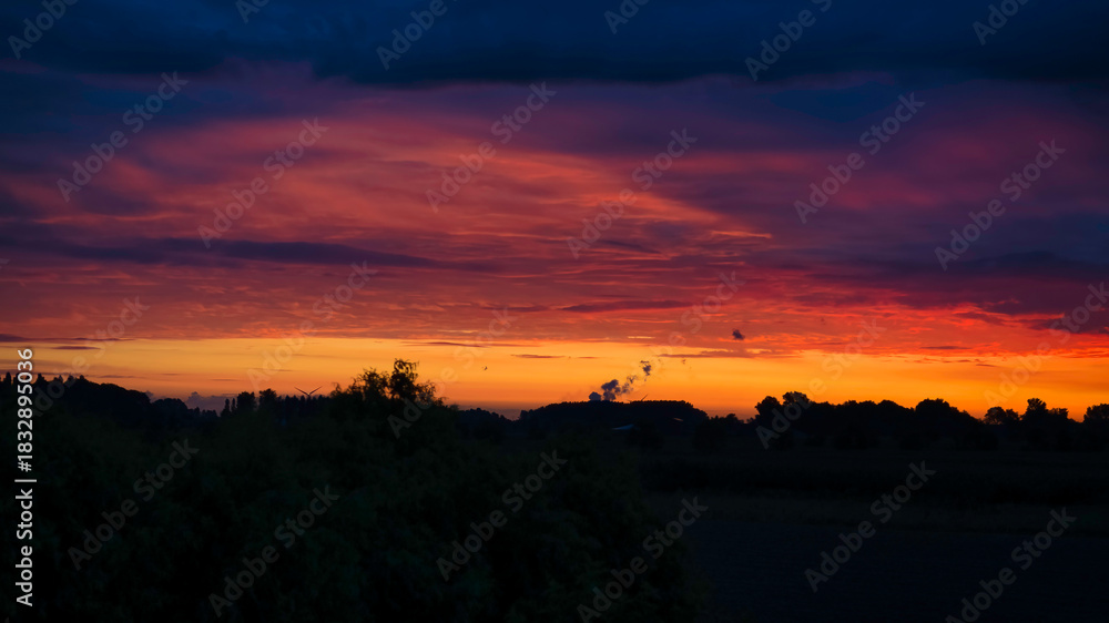 Fototapeta premium Rural silhouettes with a spectacular sunset as background