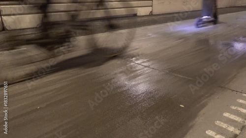 Stockholm, Sweden Bicycles on a rainy bike path at night.