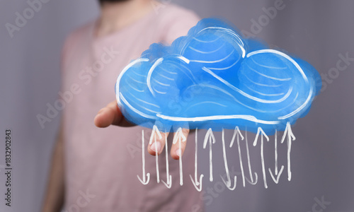 Hand holding a cloud with a...