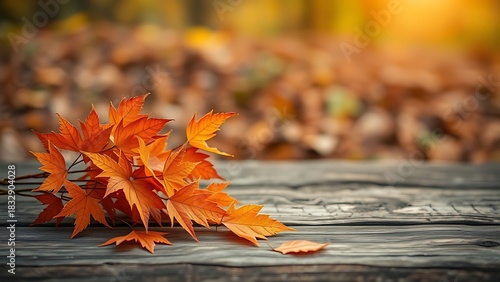 Wooden table with autumn orange leaves in a rustic seasonal composition.