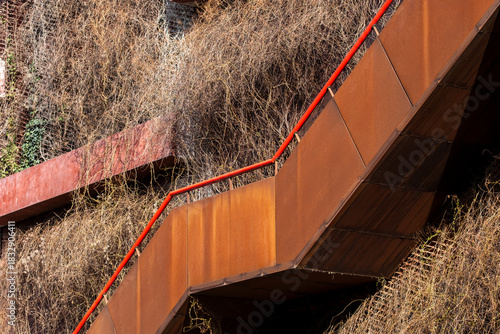 A concise architecture view showing a staircase moving through geometry along a compact structure supported by urban metal detail revealing modern symmetry shaped by coherent minimal design choices