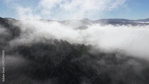 Flying through the morning mists over fields and mountains