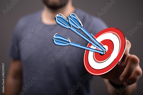 A man's hand holding a targ...