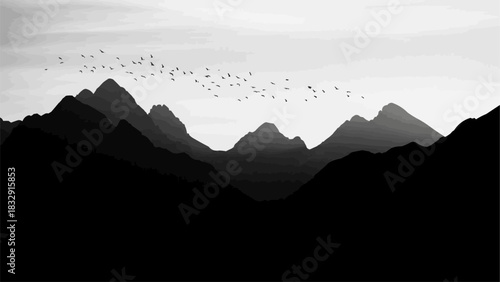 Silhouettes of birds flying over a mountain range at dusk.