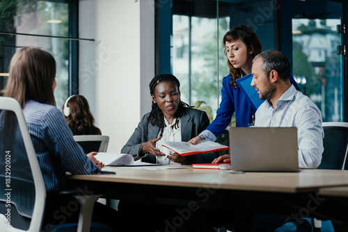 Meeting between Diverse Senior Management Team and Junior Officers in Modern Open Office Meeting