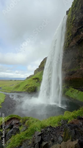 Side View of Seljalandsfoss Waterfall and Mossy Rocks