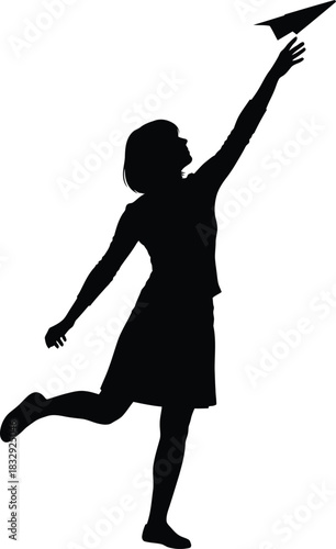 Black silhouette of woman launching paper airplane concept of dreams freedom and future