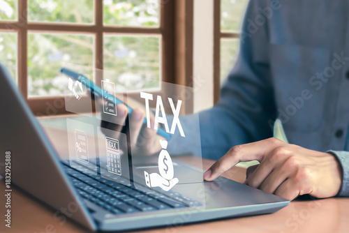 Tax return calculation concept financial research government tax businessman using laptop filling out income tax form online for payment	