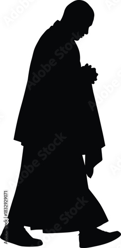 Monk or religious figure silhouette walking and praying with clasped hands