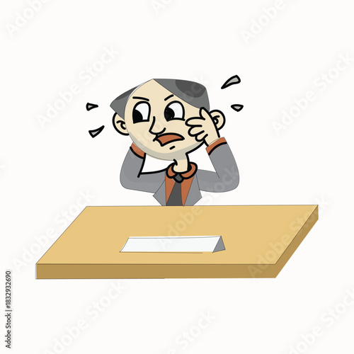 Stressed businessman pulling his hair while sitting at an office desk