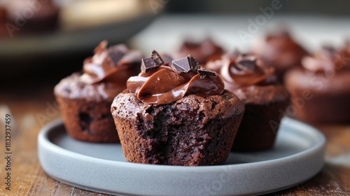 Delicious chocolate brownie muffins topped with chocolate cream and chocolate chips