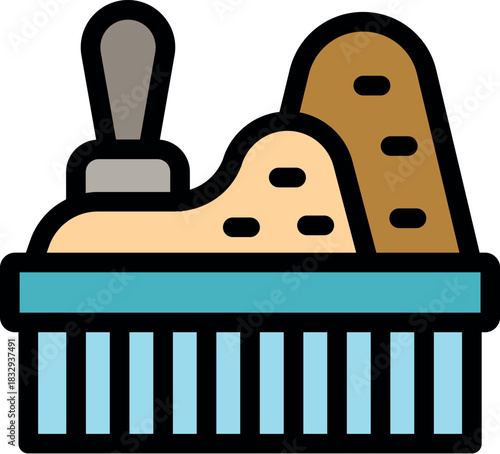 Sandbox featuring a sandcastle, shovel, and sculpted sand, evoking a miniature beach landscape