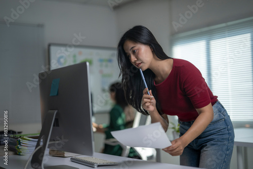 Woman concentrating on computer in modern office