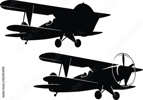 Retro biplane silhouettes flying in sky