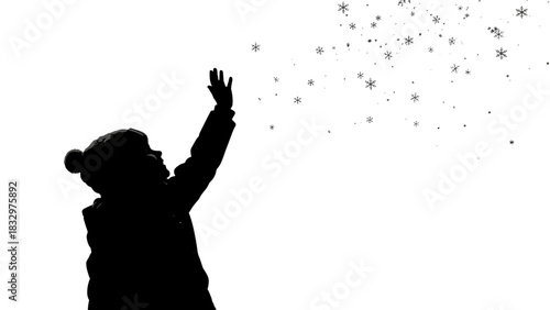 Child reaching out to snowflakes in winter silhouette  