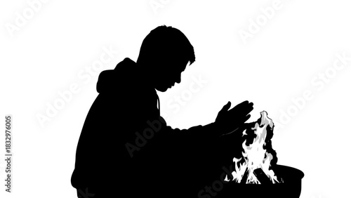 Silhouette of person warming hands by fire in dark background  