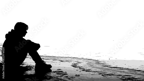 Young man sitting alone by the shore in black and white  