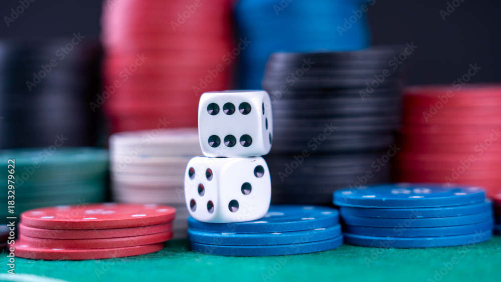 Naklejka premium Two dice are on top of a pile of poker chips. The chips are of different colors and sizes, and the dice are white. Concept of excitement and anticipation