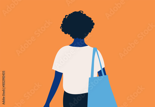 Rear view of a person with curly hair carrying a blue tote bag on an orange background.