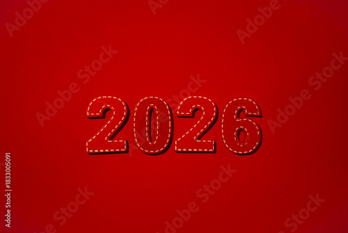 Red numbers 2026 with white stitching details standing against a vibrant red background, signifying the arrival of the New year, anticipated future, and upcoming dates