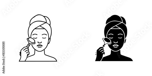 Woman with a towel on her head using a facial roller for skincare routine, isolated on