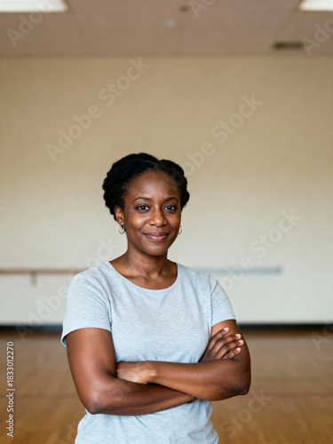Natural-light portrait of Black female fitness/wellness instructor (40s), confident pose, copy space