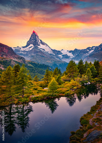 Breathtaking summer sunrise on Grindjisee lake in Swiss Alps. Astonishing morning view of  Matterhorn peak, Zermatt location, Switzerland, Europe. Beauty of nature concept background.