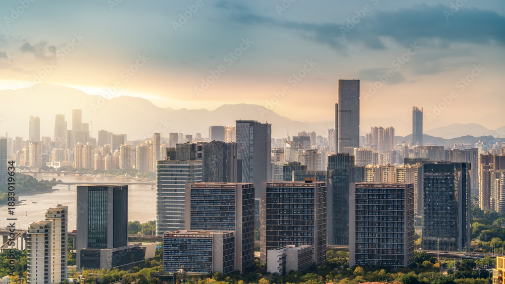 Fototapeta premium Modern city skyline with tall buildings under a cloudy sky