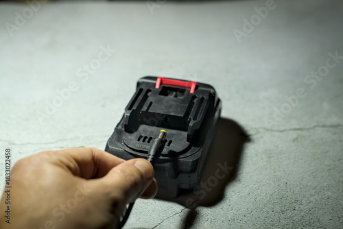 Man hold connector for li-ion battery charge