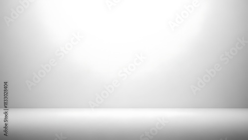 Empty white and gray studio room background with a soft spotlight for product presentation.