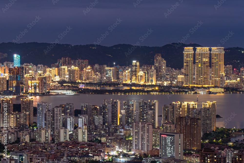 Fototapeta premium Beautiful night view of city skyline with illuminated buildings
