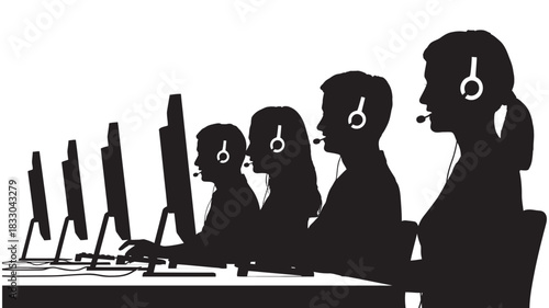 Silhouette of customer service agents wearing headset working at computer monitor in call center environment