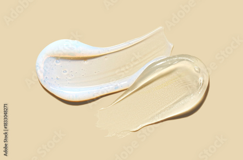 Set of two beauty products serum, mask or emulsion smudges on creamy yellow background. Beauty product sample swatch