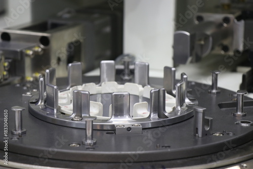 Electric motor stator coil winding machine with a view of its working station. Slot of stator copper winder device