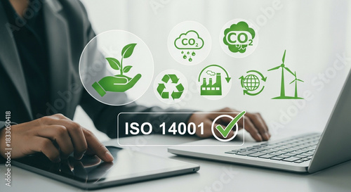 Iso 14001 certification concept showcasing environmental management standards with a person using a tablet and laptop highlighting sustainability green energy and corporate responsibility initiatives