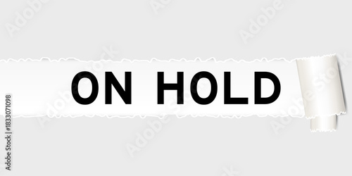 Ripped gray paper background that have word on hold under torn part