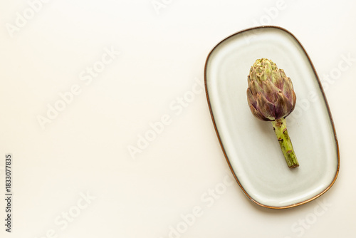 Wallpaper Mural One artichoke flower - purple edible bud on a plate top view. Vegetables food ready to cook Torontodigital.ca