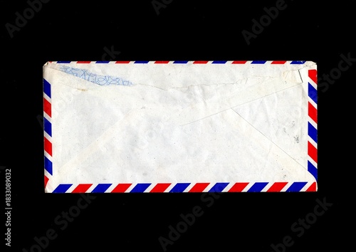 Reverse of a tatty old vintage Air Mail envelope on a black background.